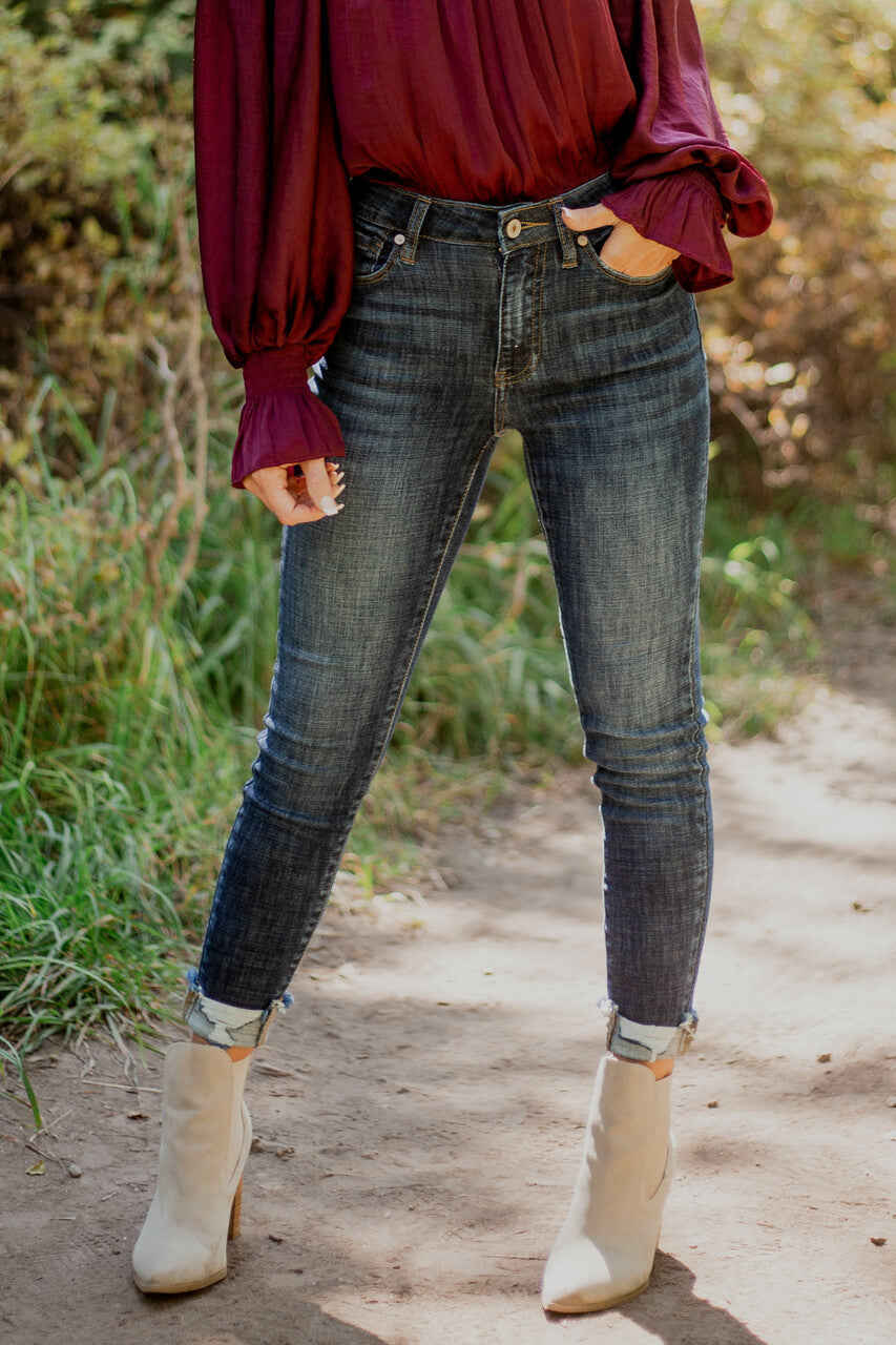 Dark Wash High Rise Skinny Jeans with Distressed Hemline