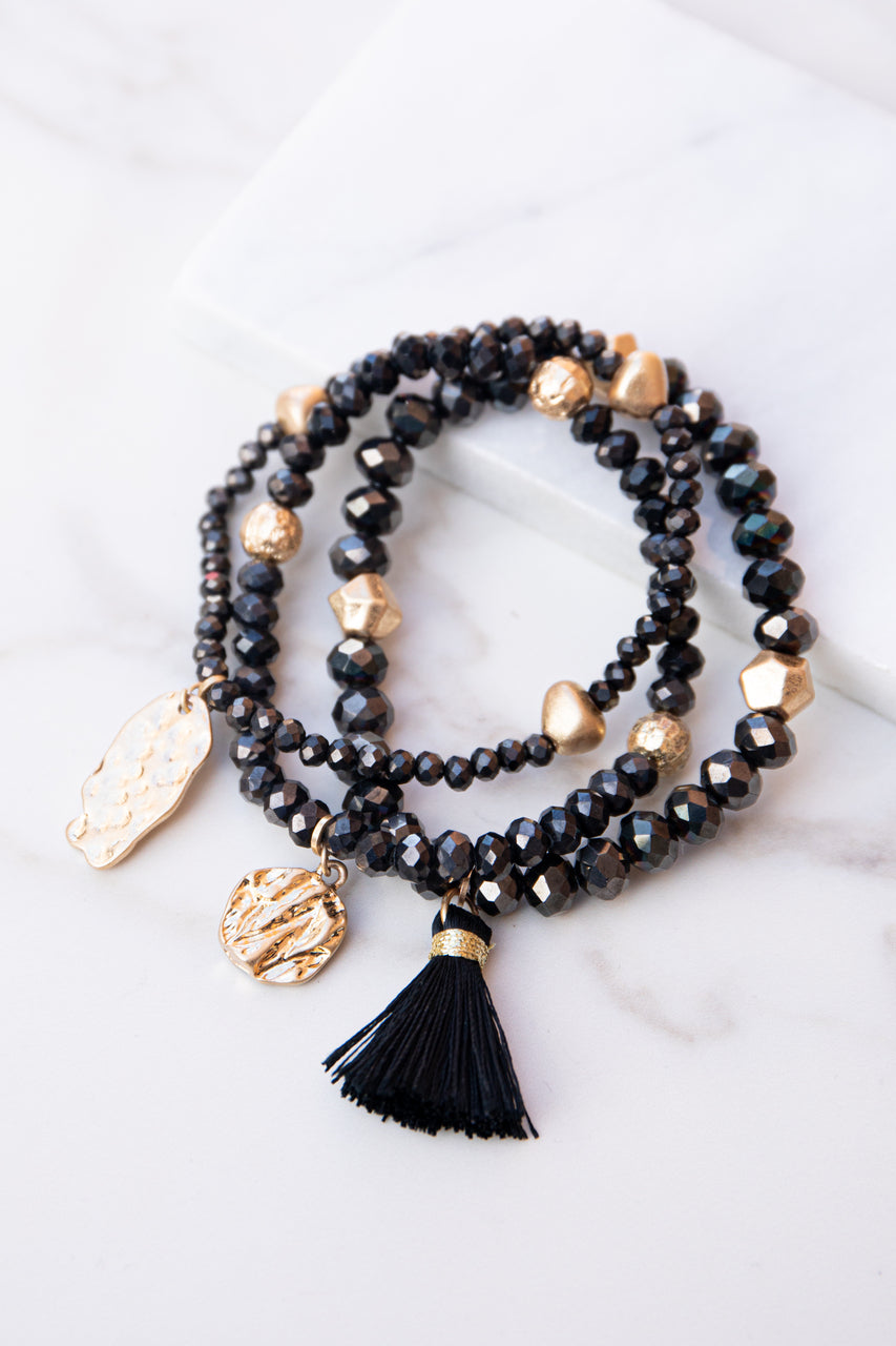 Black and Gold Beaded Bracelet Set with Tassel and Charms