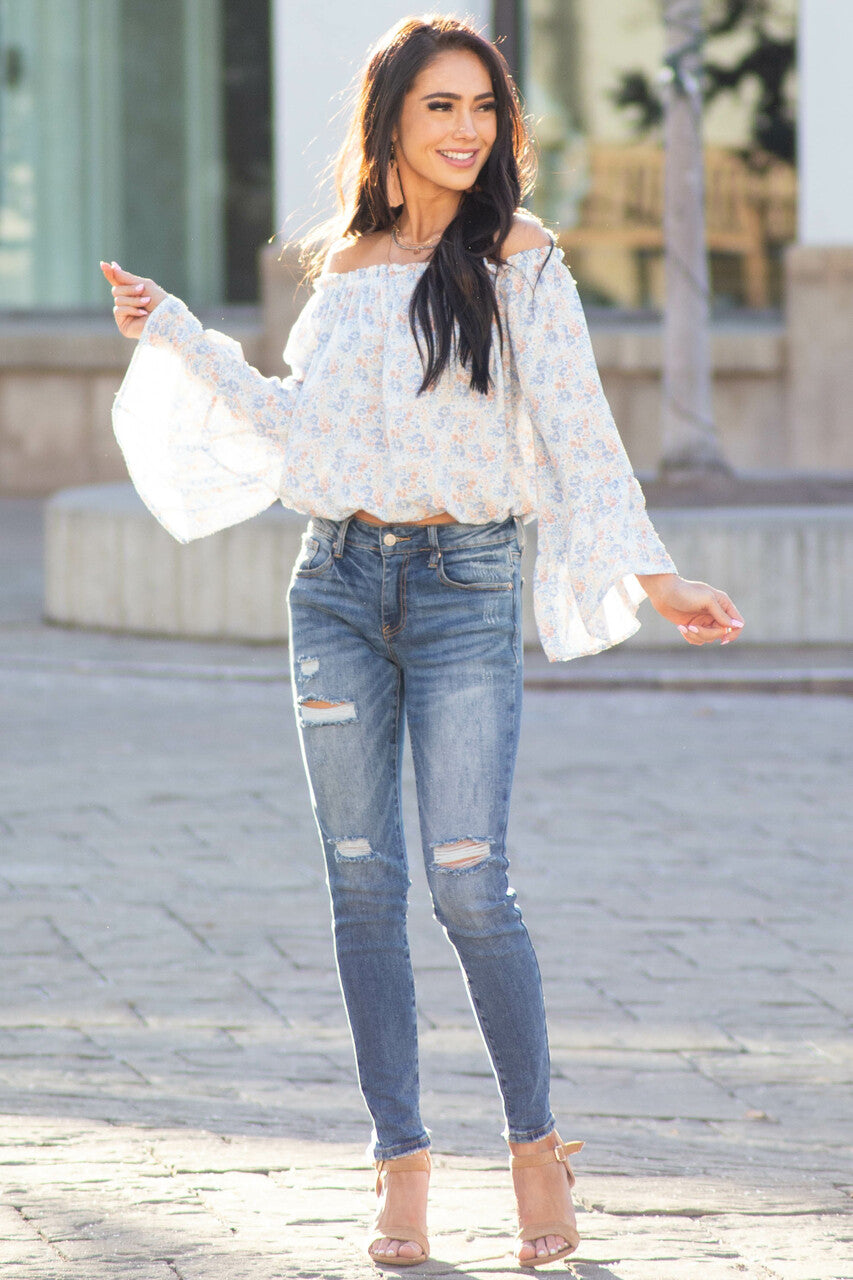 Medium Wash Mid Rise Skinny Jean with Light Distressing